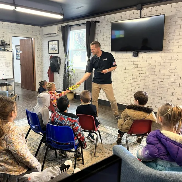 Josh Cypher showing a kindergarten class around the Popular Patch shop