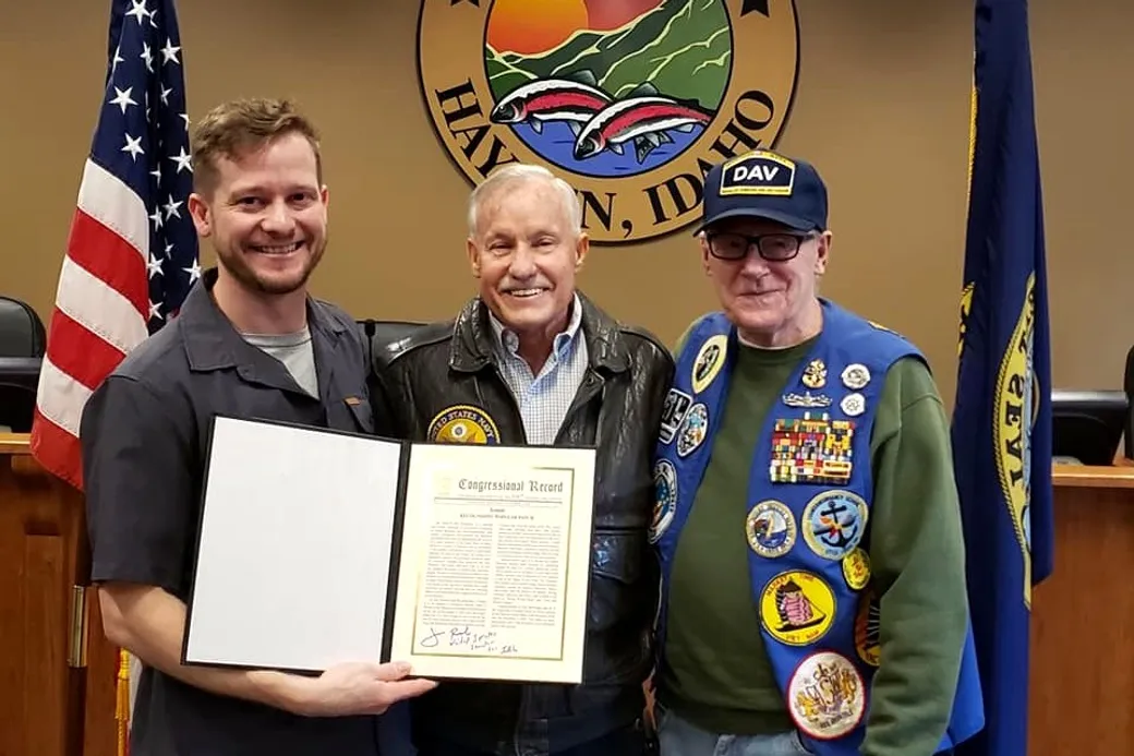 Josh Cypher with his grandfather and uncle, holding the Congressional Record recognition for Popular Patch